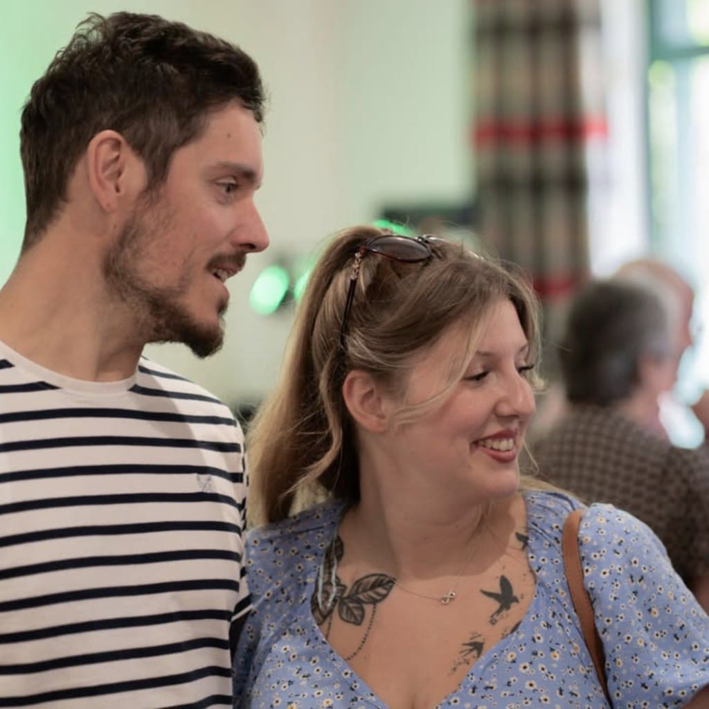 A couple smiling together at a wedding fair