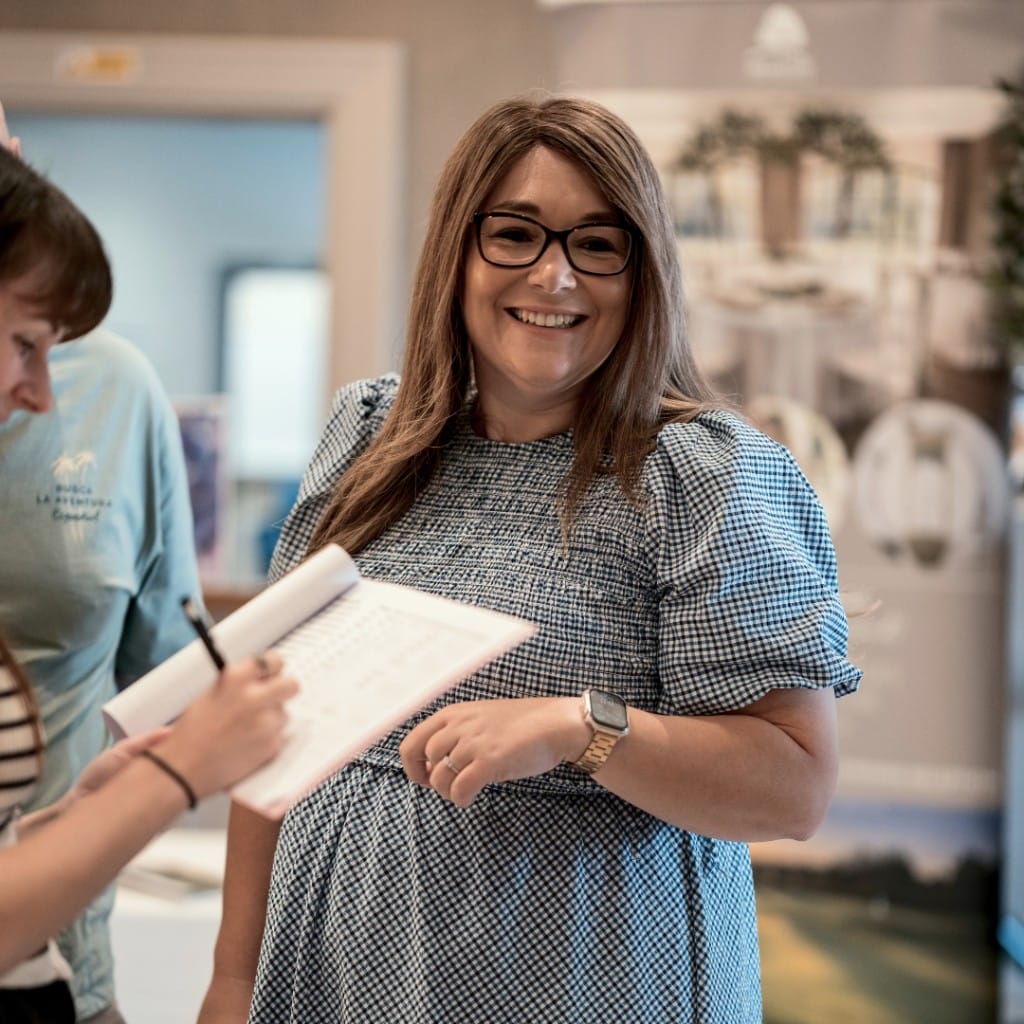 A conversation over a notebook at a Little Rain Events wedding fair